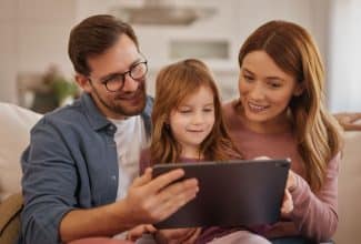 Padre e hijo usando una tablet juntos en casa.
